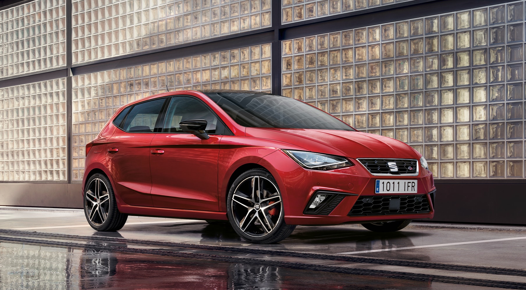SEAT Ibiza parked outside in a red scene behind SEAT Ibiza parked outside in a red scene behind